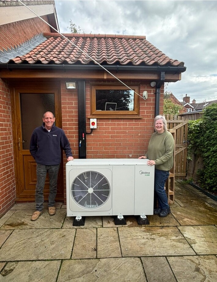 Infinity Heat Pumps customer handover beside a completed Midea installation
